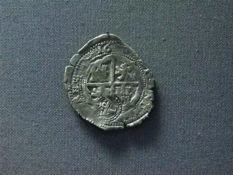 Cross inside a circle with inscriptions on a coin